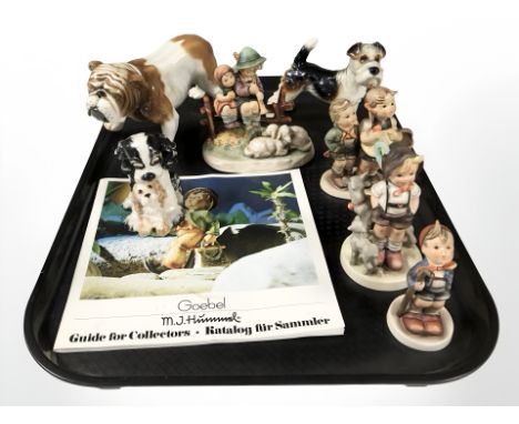 A group of Goebel figures of boys and girls, bulldog and two further dog ornaments.
