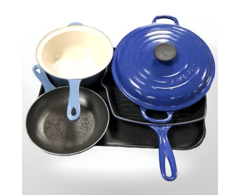 A Le Creuset enameled cast iron saucepan, skillet, a further pan and a twin handled lidded dish.