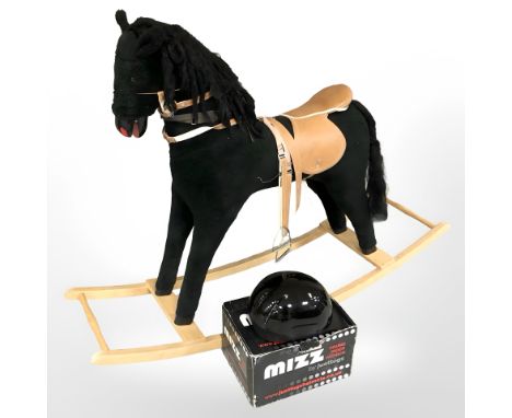 A contemporary rocking horse, length 145 cm together with a riding hat 