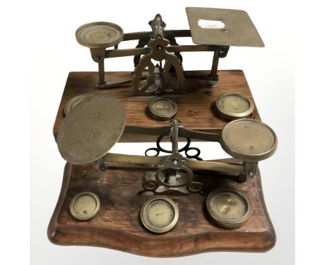 Two sets of Victorian oak and brass letter scales with weights.