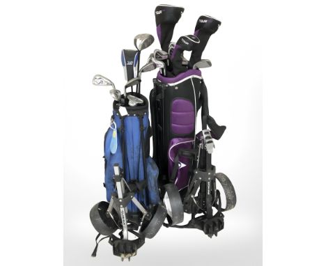 Two golf bags on caddies containing assorted irons and drivers including Calloway, Dunlop