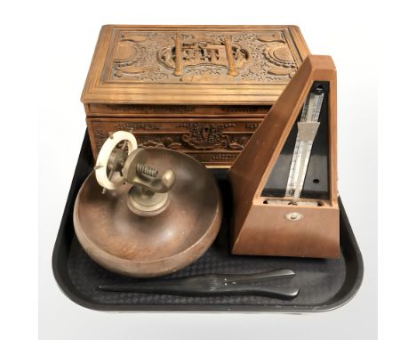 An Eastern carved wooden jewellery box, a metronome, a nutcracking bowl and a pair of ebony glove stretchers. 