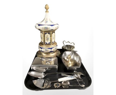 A musical ceramic cigarette dispenser on gilt brass paw feet, assorted cutlery, EPNS cigarette box, etc. 
