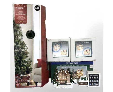 An artificial Christmas tree, light up village scene and similar ornaments. 