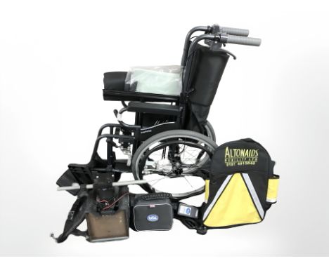 A Karma folding wheelchair and a TGA leisure motorised kart with charger and battery pack.