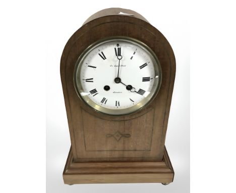 An Edwardian inlaid mahogany eight day domed mantle clock, retailed by De Carle Brothers, London, striking on a gong, height 