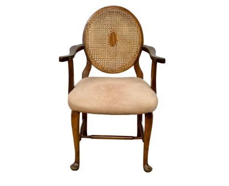 A vintage armchair with bergere back. 