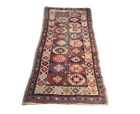 A large vintage Middle Eastern hand knotted runner rug. 255x106cm 