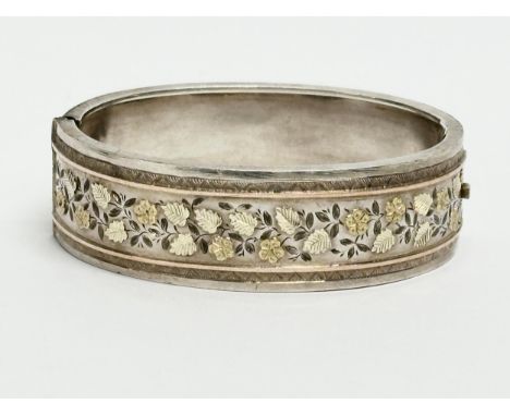 A late 19th century ornate silver bangle. 28.68 grams. 6.5x5cm 
