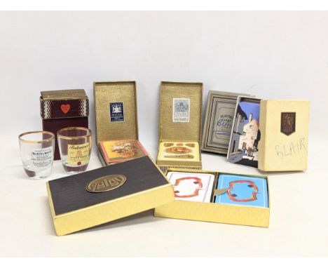 A collection of vintage playing cards with 2 whisky shot glasses. 