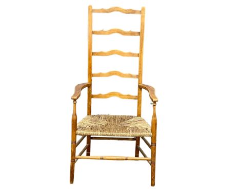 A vintage ladder back armchair with rush seat. 