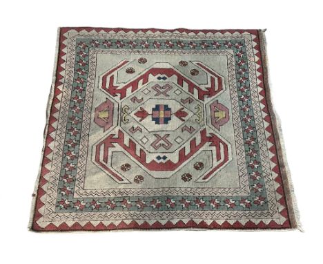 A vintage Middle Eastern hand knotted rug. 151x151cm 