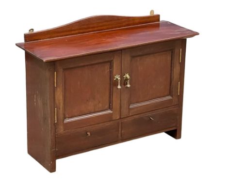 An Edwardian mahogany wall cabinet with glass interior shelf and 2 drawers. 62x21x48cm (8) 