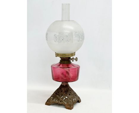 A late Victorian brass oil lamp with Ruby Glass bowl. 55cm 