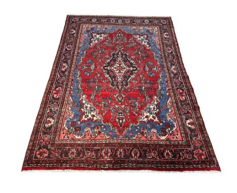 A large vintage Middle Eastern hand knotted rug. 311x207.5cm 