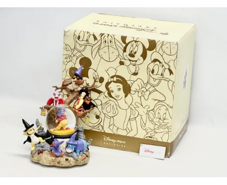 A Disney Store Exclusive ‘Winnie the Pooh’ musical snow globe with box. Snow globe measures 20x27cm. Box 35.5x27.5x36.5cm 