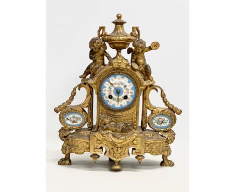 A mid 19th century Henry Marc gilt brass mantle clock, decorated with cherubs and hand painted porcelain face and panels. Par