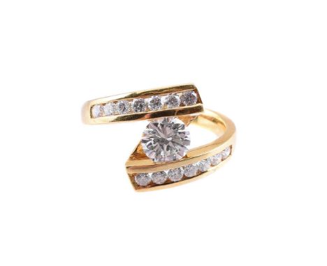 
	
		A DIAMOND CROSSOVER RING
		The principal brilliant cut diamond suspension set between crossover channel set brilliant cu