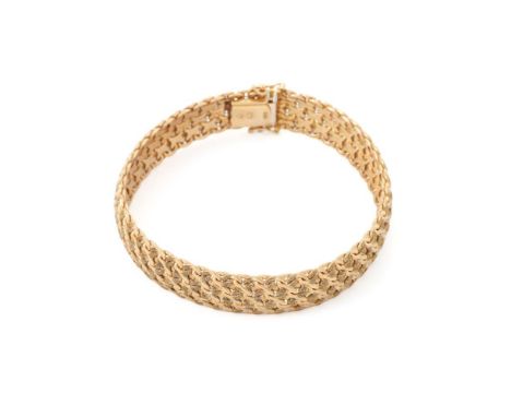 
	
		A GOLD COLOURED BROAD BRACELET 
		The textured woven links to a concealed clasp, stamped 9Kt Italy
		Size/dimensions: 18