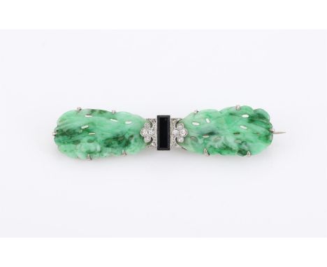 
	
		A 1930S AND LATER JADEITE JADE, DIAMOND AND ONYX BROOCH 
		The oval jadeite panels carved with birds amongst foliage, wi