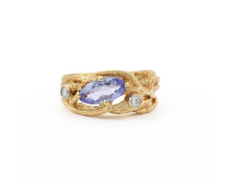 
	
		ALBION CRAFT CO., A DIAMOND AND TANZANITE DRESS RING 
		LONDON 1988
		With a marquise cut tanzanite between two brillian