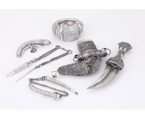 A COLLECTION OF SILVER OMANI ITEMS To include: a silver mounted dagger and scabbard with filigree decoration, 28cm (11in) hig