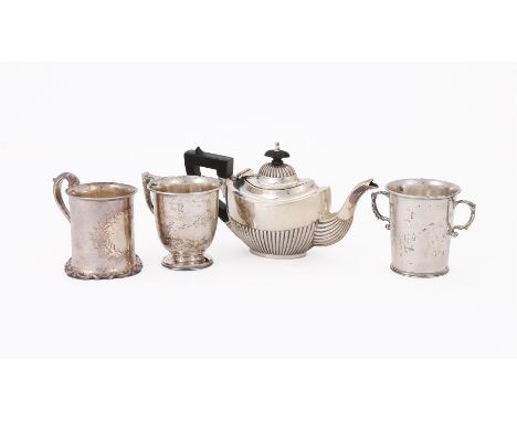 
	
		FOUR SILVER ITEMS
		To include: an Edwardian oval half lobed tea pot by Arthur Fenwick, Birmingham 1901, with a wooden l