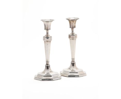 
	
		A PAIR OF SILVER OCTAGONAL CANDLESTICKS
		HAWKSWORTH, EYRE &amp; CO. LTD., SHEFFIELD 1912
		With reeded octagonal sconce