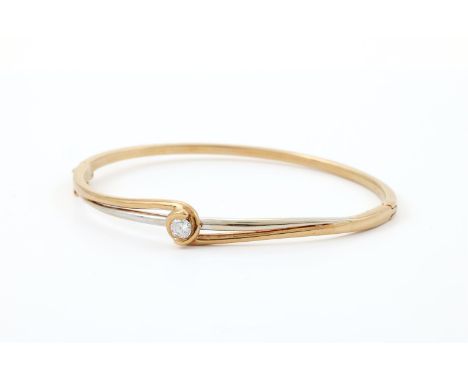
	
		AN 18 CARAT GOLD AND DIAMOND HINGED BANGLE 
		SHEFFIELD 1989 IMPORT MARK 
		The two colour hinged bangle with a brillian