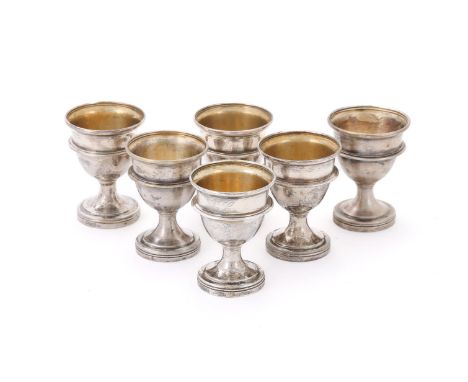 
	
		SIX INDIAN COLONIAL SILVER EGG CUPS
		Engraved KC, with a girdle and on circular moulded spreading pedestal feet
		6.5cm