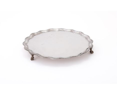 
	
		A LATE VICTORIAN SILVER SHAPED CIRCULAR SALVER
		R. &amp; S. GARRARD &amp; CO., LONDON 1897
		With a beaded raised mould