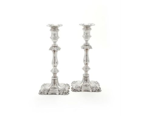 
	
		A PAIR OF SILVER CANDLESTICKS
		BARKER ELLIS SILVER CO., BIRMINGHAM 1973
		The shaped square sconces with shells to the 