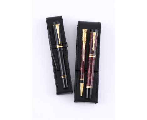 
	
		PARKER, DUOFOLD, A BURGUNDY MARBLED FOUNTAIN PEN AND BALLPOINT 
		Cap and Barrel: With marbled cap and barrels, gilt arr