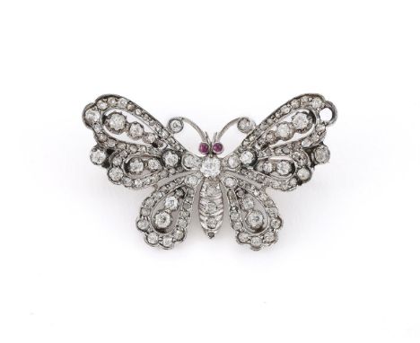 
	
		A LATE VICTORIAN AND LATER DIAMOND AND RUBY BUTTERFLY BROOCH 
		The butterfly set with old cut and rose cut diamonds, wi