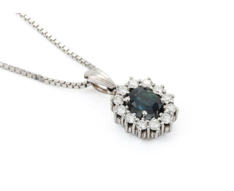 
	
		A SAPPHIRE AND DIAMOND CLUSTER PENDANT 
		The oval cut sapphire within a diamond surround, approximately 0.30 carats tot
