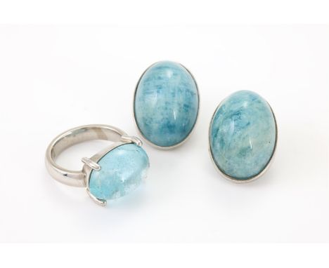 
	
		AN AQUAMARINE RING AND A PAIR OF SIMILAR EAR CLIPS
		The ring with an oval cabochon in a four claw setting, stamped 750 