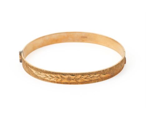 
	
		A 9 CARAT GOLD BANGLE 
		BIRMINGHAM 1971 
		With engraved decoration to the front, with concealed clasp
		Size/dimension