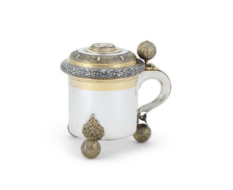 
	
		A SWEDISH SILVER AND SILVER GILT LIDDED TANKARD
		NATIONAL CONTROL MARK, CIRCA 1945
		The ogee domed cover with a ball t