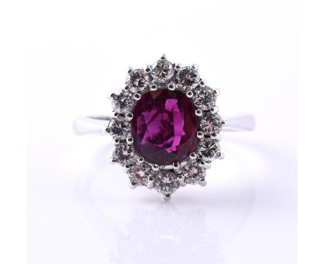 
	
		A RUBY AND DIAMOND CLUSTER RING 
		LONDON 1974
		The oval cut ruby within a surround of brilliant cut diamonds, approxim