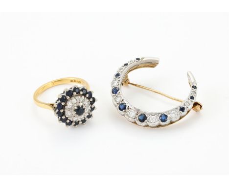 
	
		A SAPPHIRE AND DIAMOND CLUSTER RING AND CRESCENT BROOCH
		The ring with a target cluster of circular cut sapphires and e