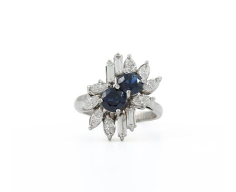 
	
		A SAPPHIRE AND DIAMOND CLUSTER DRESS RING 
		The two circular cut sapphires within a surround of marquise cut and baguet