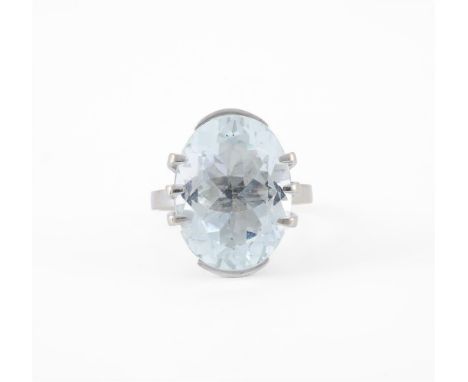 
	
		AN AQUAMARINE DRESS RING 
		The oval cut aquamarine estimated to weigh 7.84 carats, within a raised claw and part collet