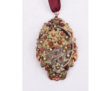 
	
		A LATE 19TH/EARLY 20TH CENTURY SILVER GILT SYNTHETIC RUBY AND HALF SEED PEARL BIRD LOCKET PENDANT
		The front section wi