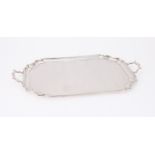 AN EDWARDIAN SILVER TWIN HANDLED SHAPED RECTANGULAR TRAY