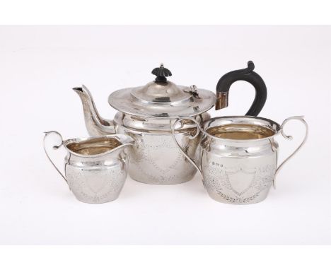 
	
		AN EDWARDIAN MATCHED SILVER OVAL THREE PIECE TEA SET
		THE TEA POT AND CREAM JUG BY JOHN ROSE, BIRMINGHAM 1905, THE SUGA