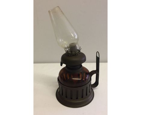 A vintage wall hanging brass and glass oil lamp.