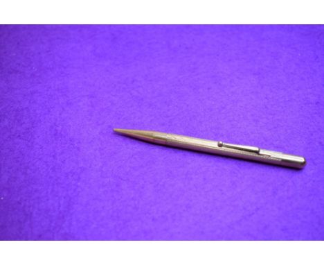 A Fyne Poynt propelling pencil in gold with engine turned decoration