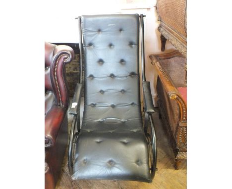 A black painted Iron rocking chair in the style of R.W. Winfield & Co. with black leather button back seat