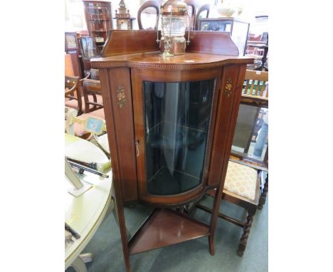 EDWARDIAN INLAID CABINET, mahogany inlaid and floral painted corner cabinet with curved glass door and shelf base, 52" height