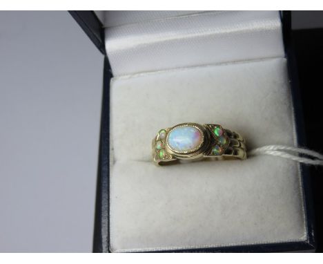 OPAL RING, 9ct yelow gold ring set an oval opal with opal shoulders, size O/P